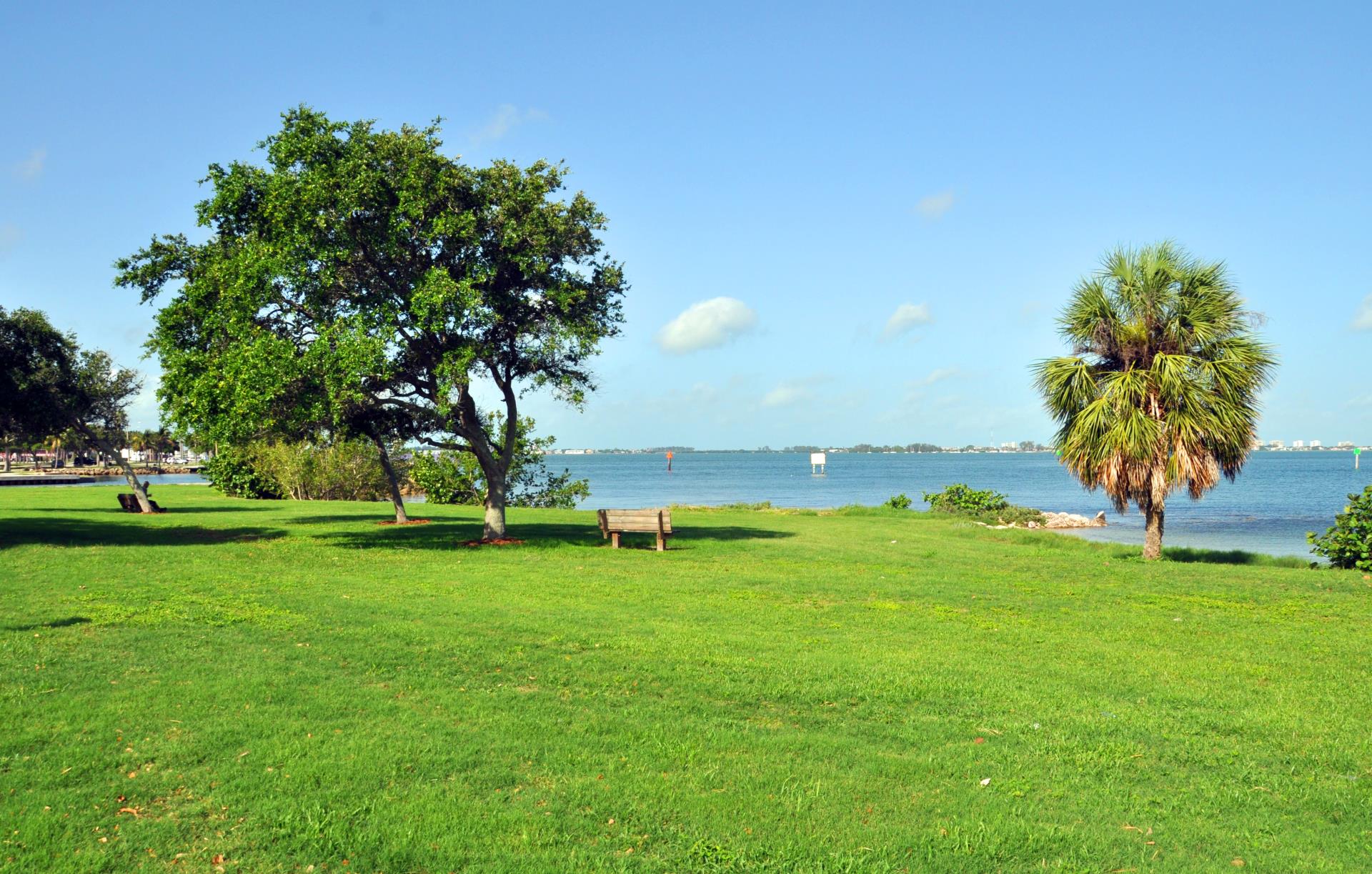 Centennial Park open field facing the water with benches