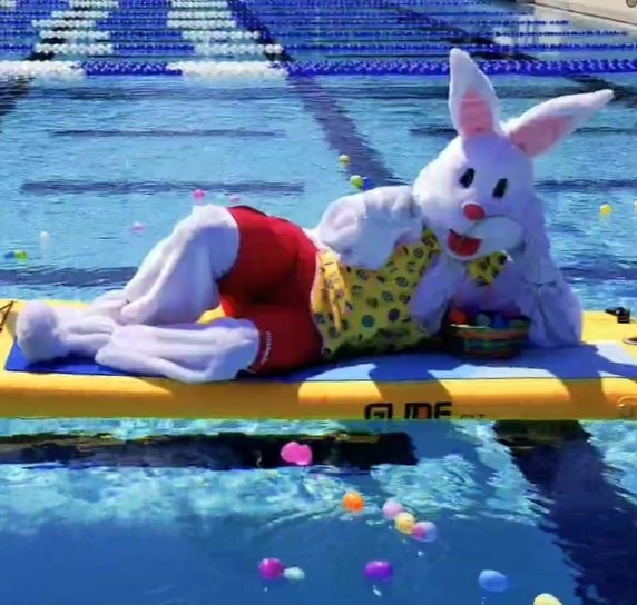 Bunny costume resting on a floating yoga board in the pool